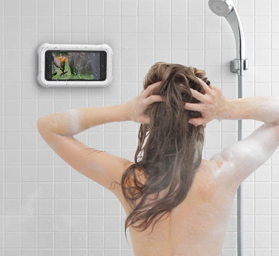 ShowerDock mounted on shower tiles beside a person washing their hair